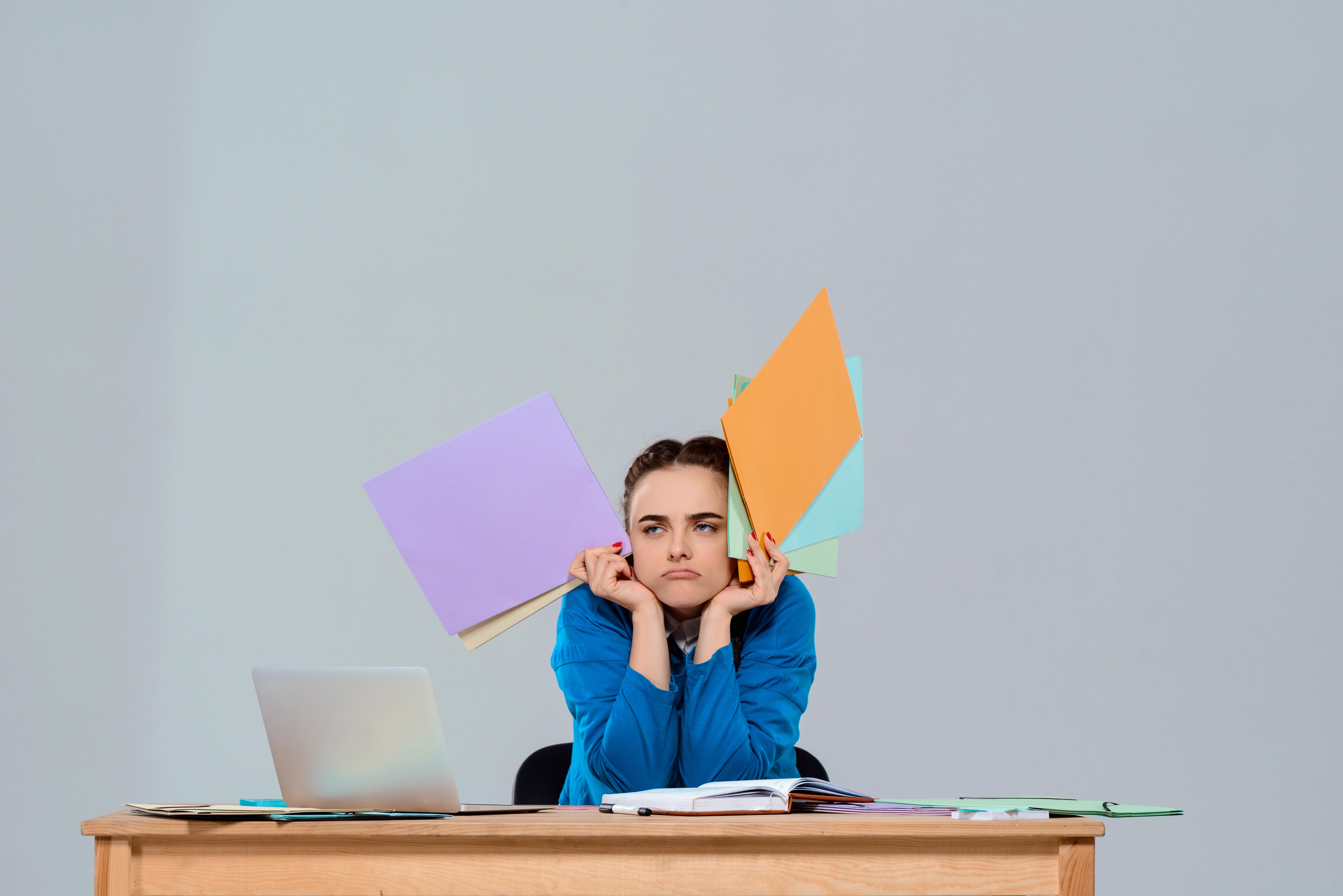 A person looking focused and determined at a laptop